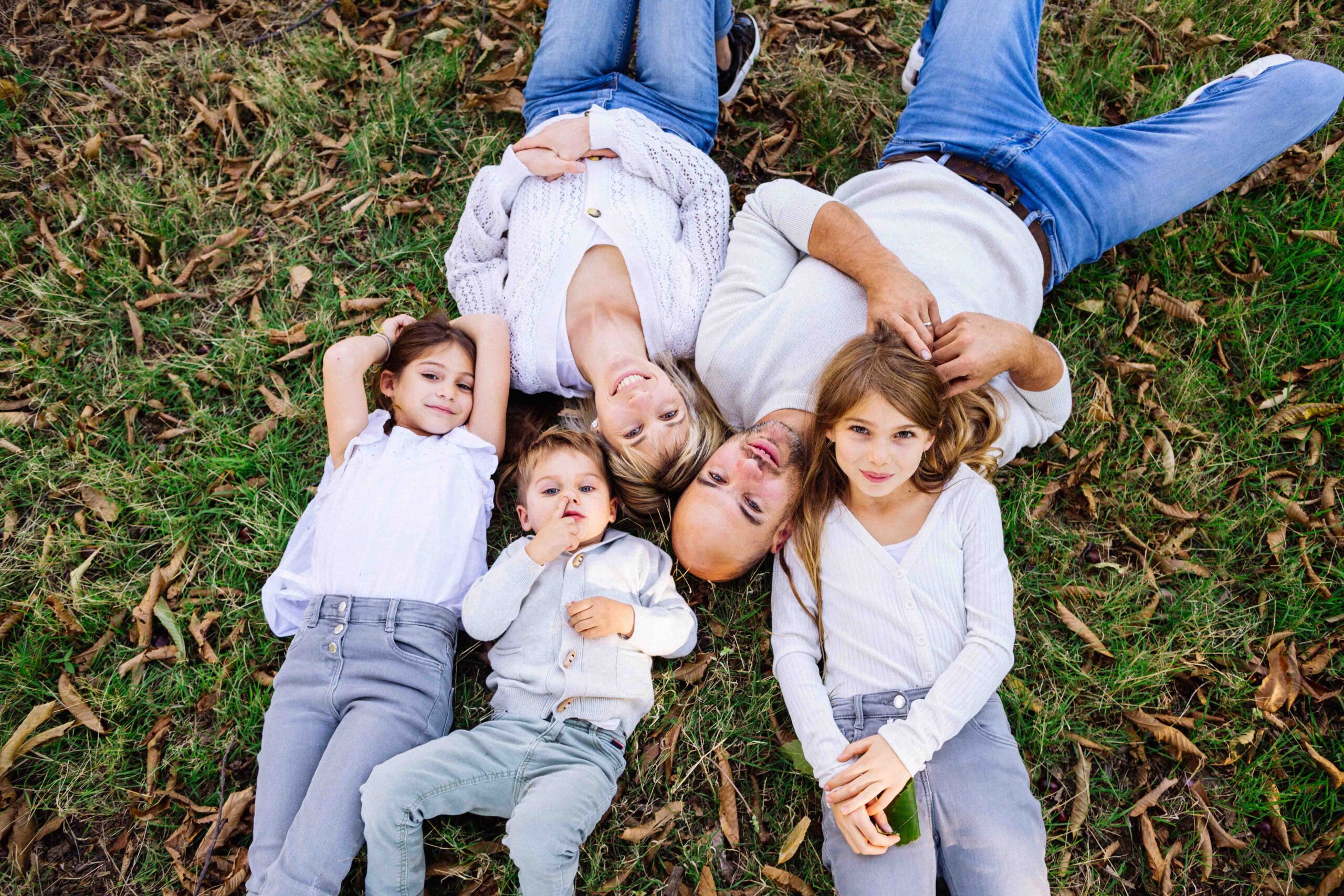 Séance photo de famille en automne dans une châtaigneraie en Ardèche, lumière naturelle et cadre forestier